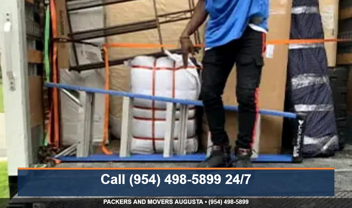 Moving crew carrying boxes into a new home in the Augusta GA area